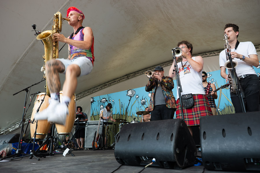 Leo Pellegrino of Too Many Zooz brings his performance from the New York City subways to the festival stage as he leaps into the air while never missing a beat on his baritone saxophone. The horn section from Five Alarm Funk lays a solid foundation for his solo.