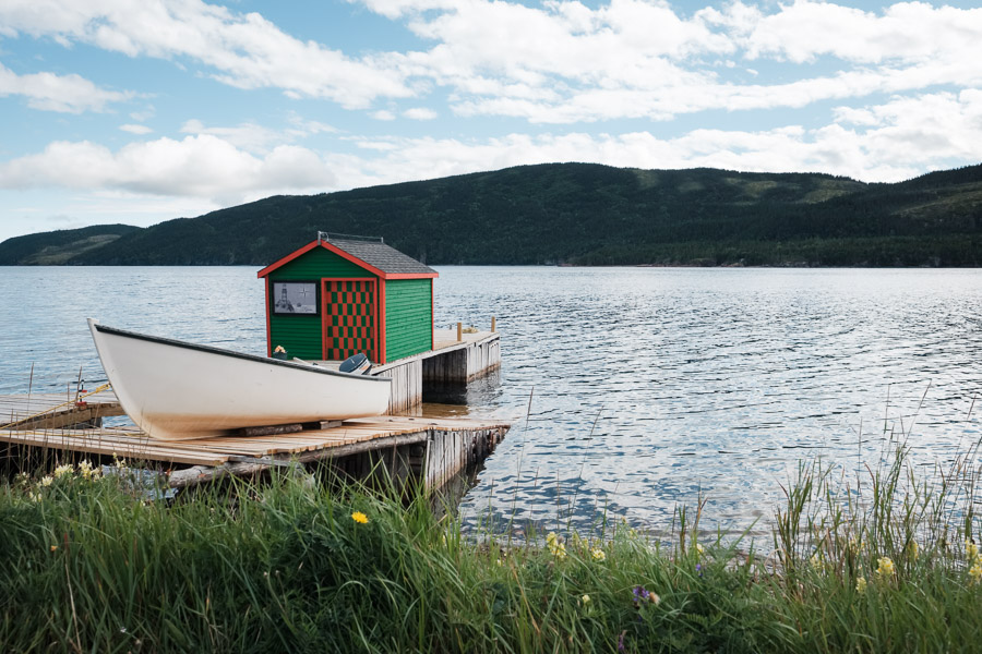 A bright fishing stand is nestled in a calm ocean inlet, shelter for a fisherman who ventures daily out into the wild waters of the North Atlantic.