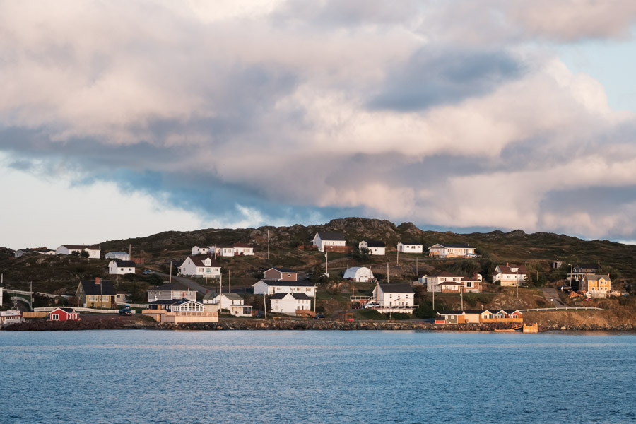 Homes in a picturesque rural fishing town dot otherwise rugged shores.