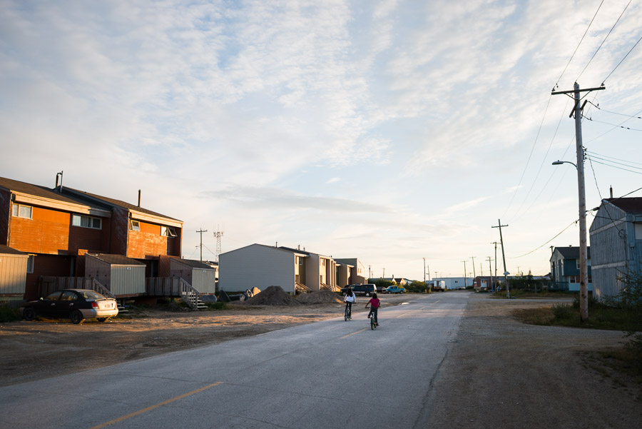 Children cycle down the quiet streets of the remote northern town.