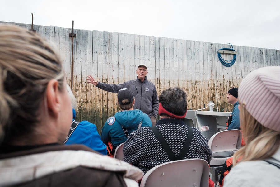 Wally Daudrich - the founder and owner of Lazy Bear Lodge and Expeditions - preps a group with boat safety necessities before they head out onto the rough waters of the Hudson Bay.
